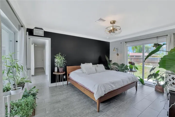 Bedroom featuring crown molding and wood-type flooring