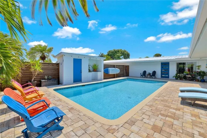 View of swimming pool with a patio area and an outdoor structure