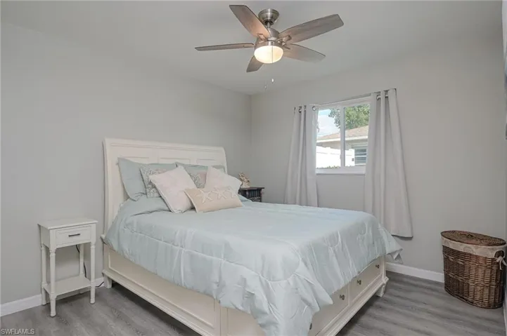 Bedroom with light wood finished floors and a ceiling fan