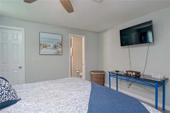 Bedroom with ceiling fan and connected bathroom