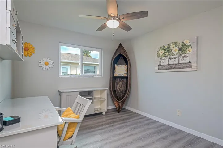 Home office featuring light wood-style flooring and ceiling fan