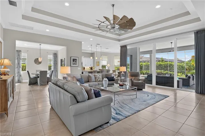 The living room opens to the lanai and pool through 10 foot impact sliding glass doors.