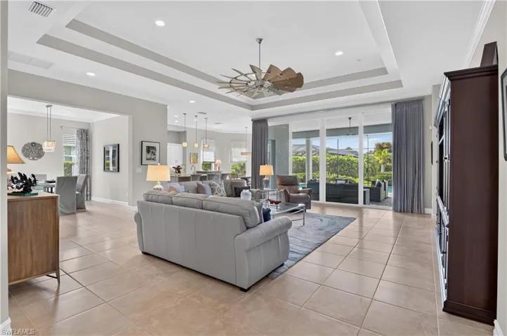 The large, open living area features a high tray ceiling.