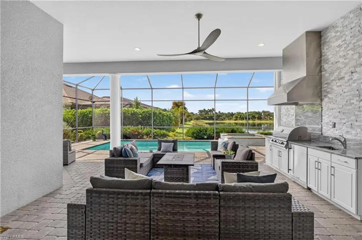 Spacious lanai with pavers and outdoor kitchen.