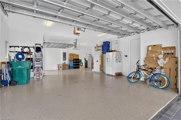 Massive garage features two garage doors and easily holds three vehicles, cooled by a split AC unit..