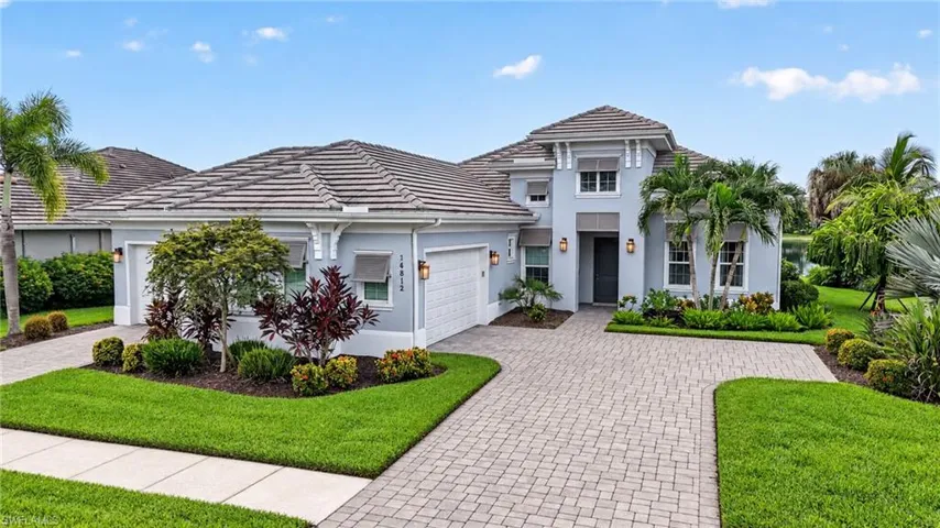Two driveways provide access to the three car garage.