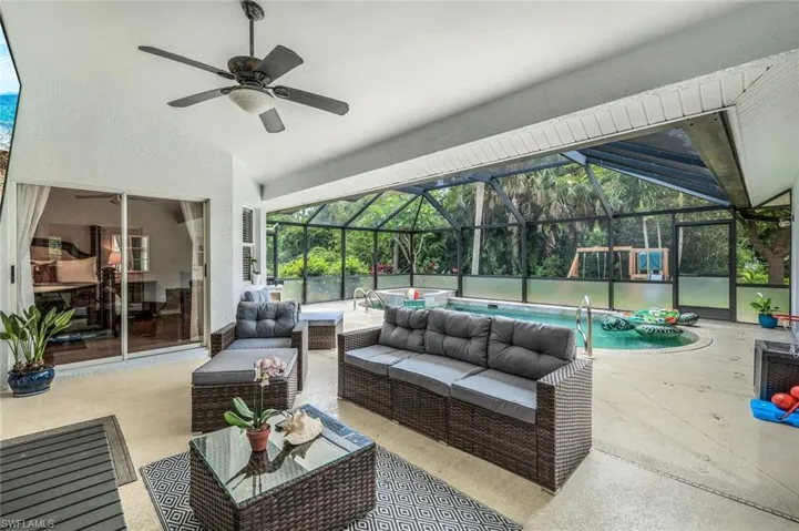 View of patio / terrace with ceiling fan, outdoor lounge area, and glass enclosure