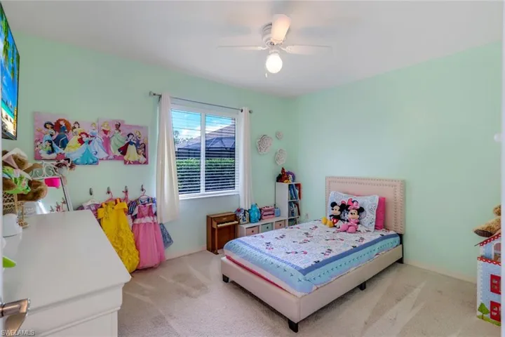 Carpeted bedroom with ceiling fan
