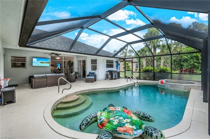 View of swimming pool featuring a patio area, an outdoor hangout area, ceiling fan, grilling area, and a lanai