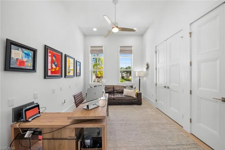 Office space with ceiling fan, light wood-style floors, and recessed lighting