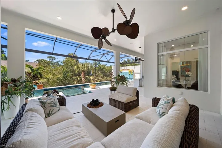 View of patio featuring an outdoor pool, a sunroom, and outdoor seating