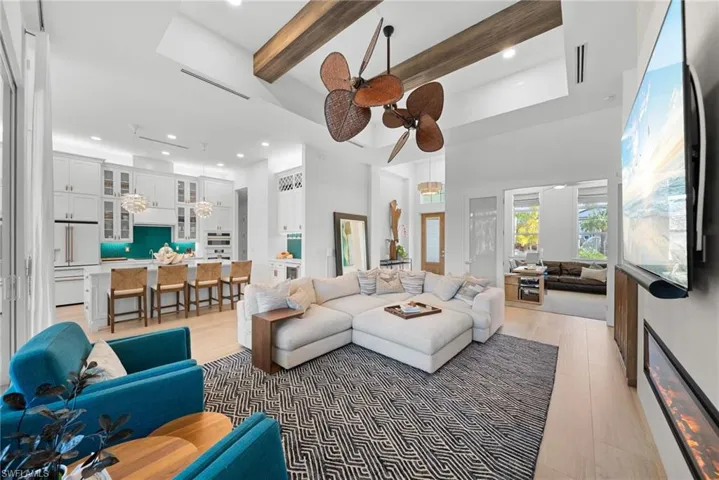 Living area featuring light wood finished floors, ceiling fan, and recessed lighting