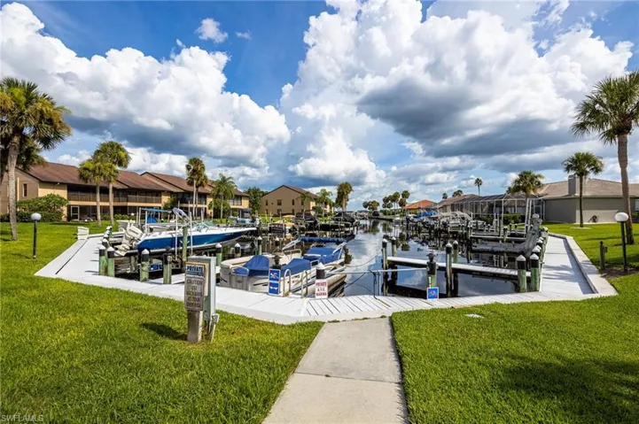 View of dock with a water view and a yard
