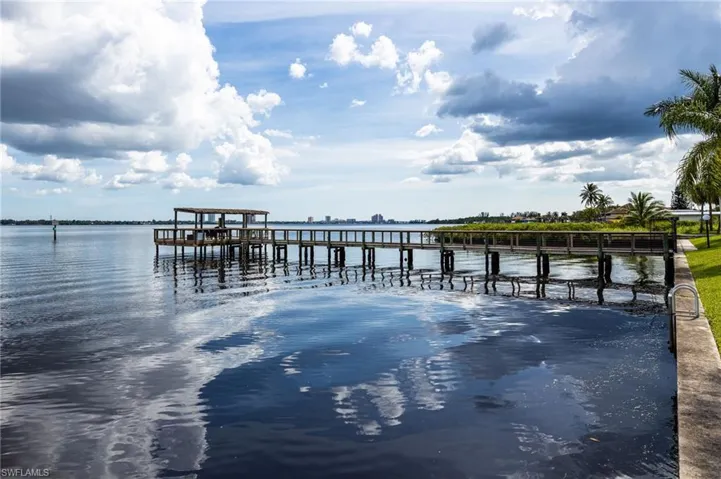 Dock area featuring a water view