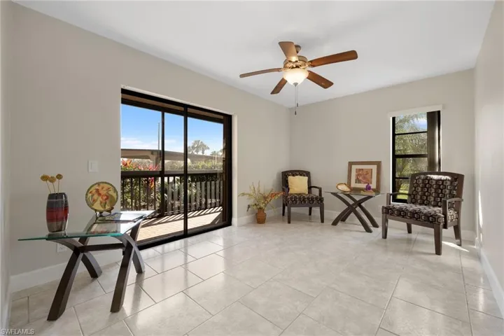 Living area featuring ceiling fan and light tile patterned floors