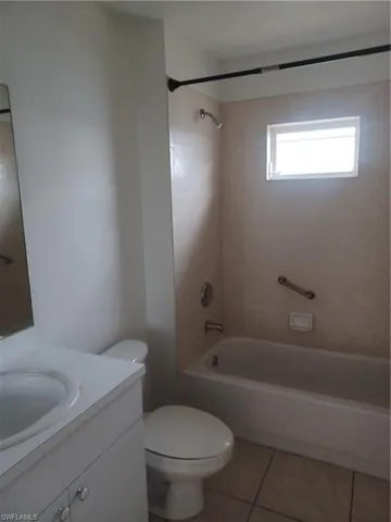 Full bathroom with vanity, shower / washtub combination, and tile patterned floors