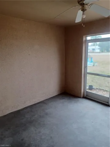 Spare room featuring concrete floors and a ceiling fan