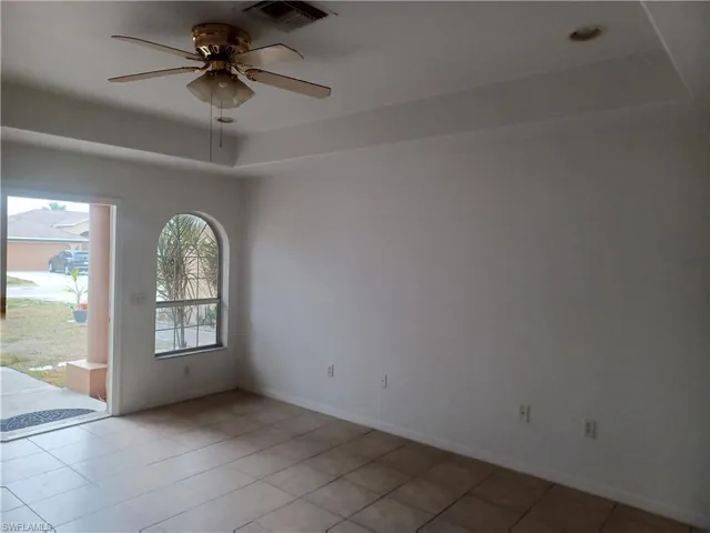 Unfurnished room featuring a ceiling fan and light tile patterned flooring