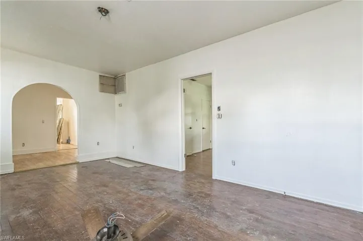 Bedroom door off the living room along with dining room off this space