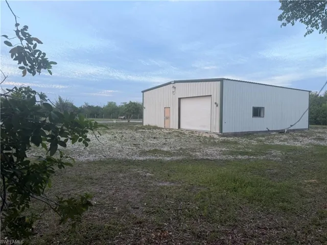 Outbuilding with 5 cleared flat acres with fqantastic location.