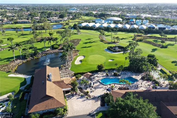 Aerial view of residential area with a local golf course and a nearby body of water
