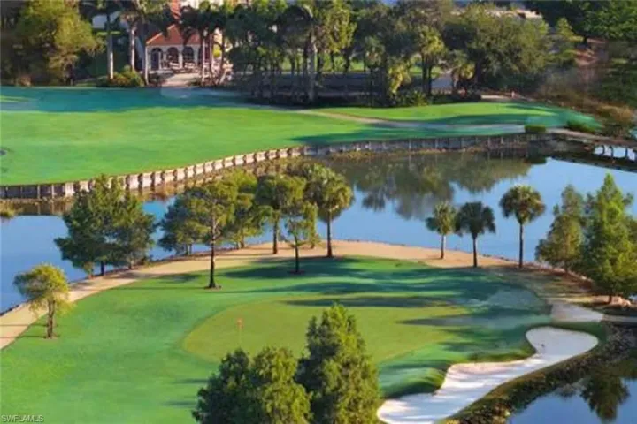 View of home's community with view of golf course, a putting green, and a water view