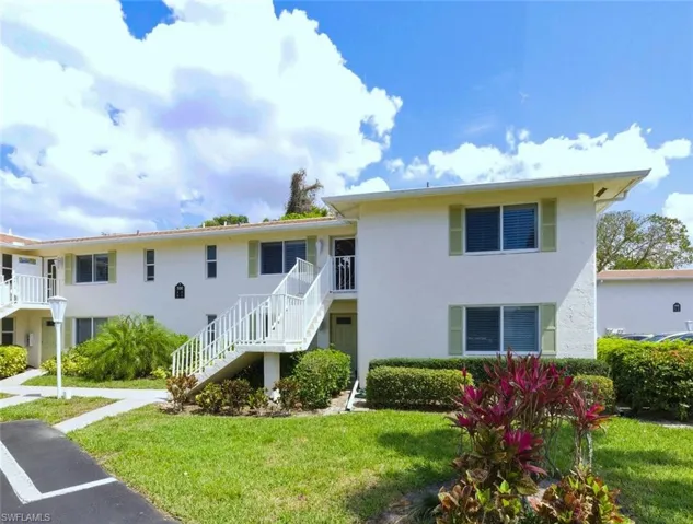 View of property with stairs