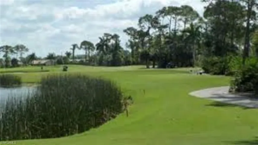 Surrounding community featuring view of golf course and a water view