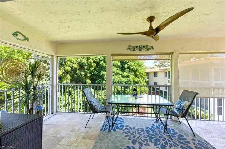 Sunroom / solarium featuring outdoor dining area, ceiling fan, and a balcony