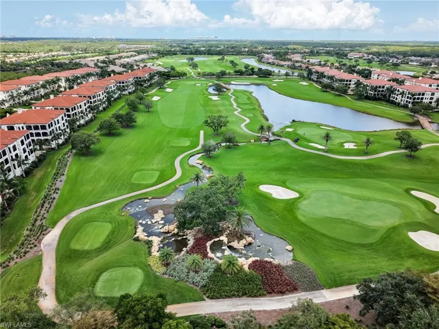 Aerial perspective of suburban area featuring a golf club and a large body of water