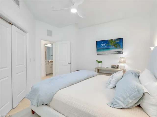 Bedroom featuring light wood-style flooring, a closet, and ceiling fan