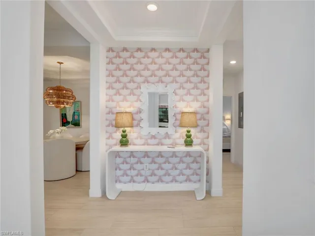 Corridor with crown molding and recessed lighting