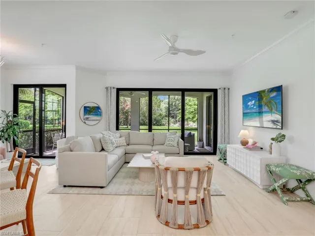 Living room with crown molding and ceiling fan