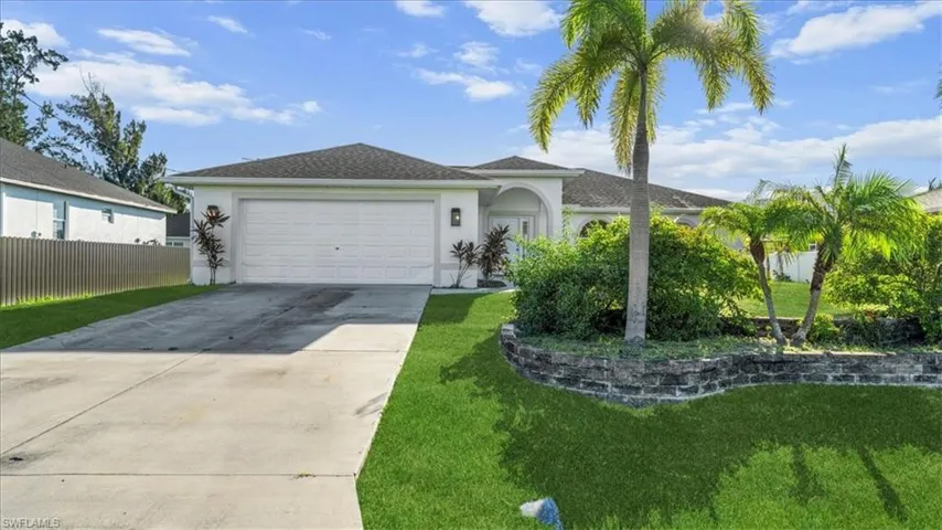 Single story home with concrete driveway, stucco siding, and a garage
