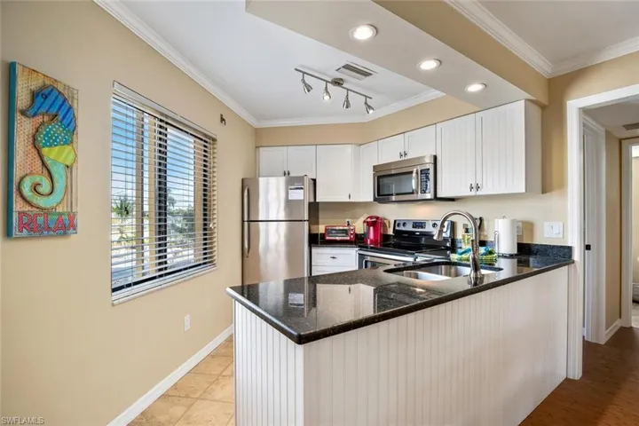 Casa Bella A Kitchen   Stainless steel appliances and granite countertops