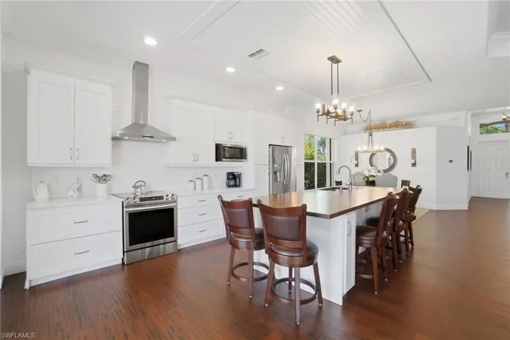 This light, bright & airy 3 bed, 2 bath pool home offers an open & split bedroom floor plan, beautiful wooden & tile floors throughout (no carpet) & a gorgeous open renovated kitchen