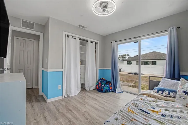 Bedroom with light wood-style floors and access to exterior