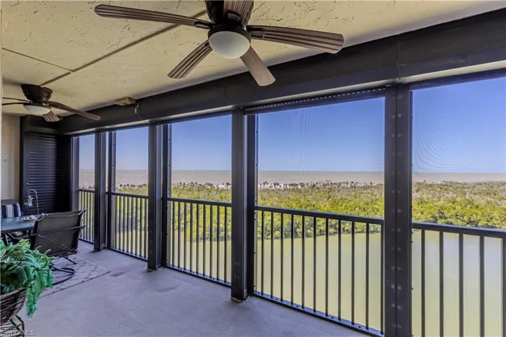 Unfurnished sunroom featuring a ceiling fan