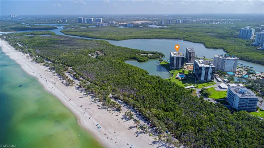 Aerial view featuring a view of the beach and a water view