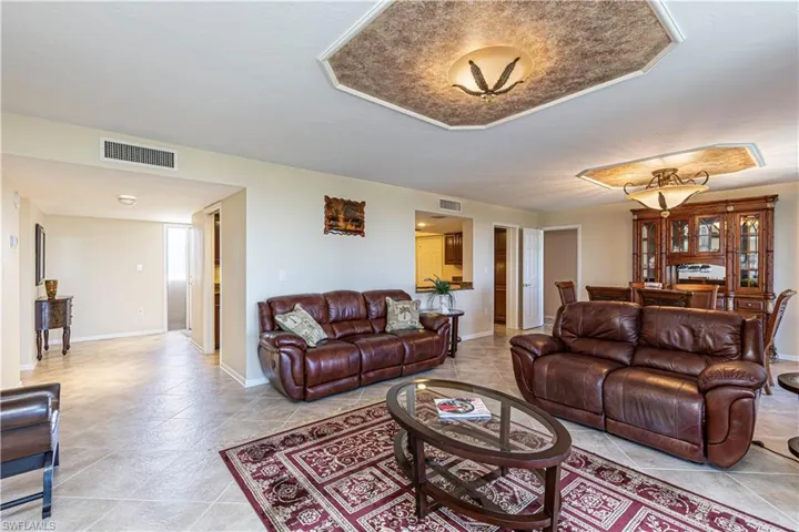 Living area featuring visible vents, baseboards, and light tile patterned flooring