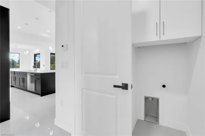 Washroom with cabinet space, hookup for an electric dryer, and recessed lighting