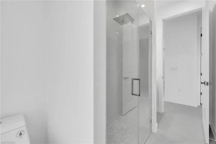 Full bath featuring a stall shower and tile patterned flooring