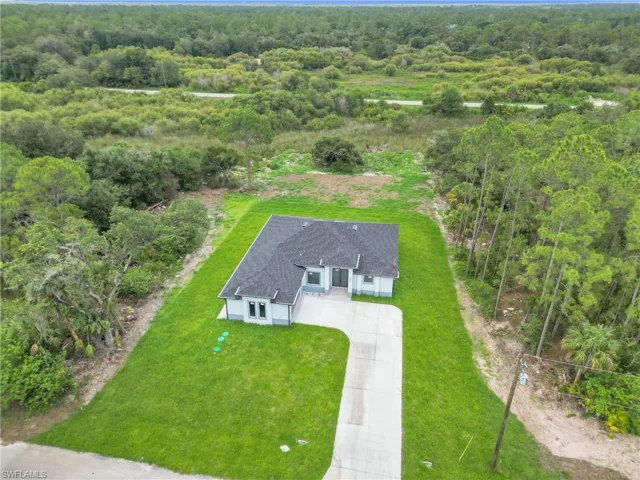 View of subject property featuring a heavily wooded area