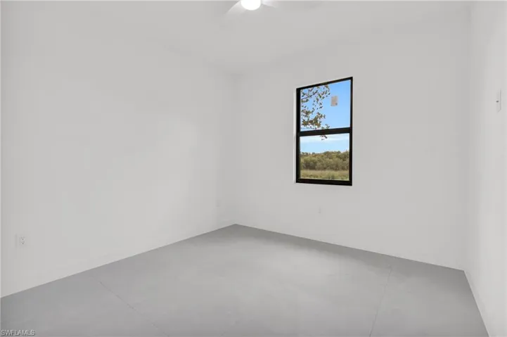 Empty room with a ceiling fan and baseboards