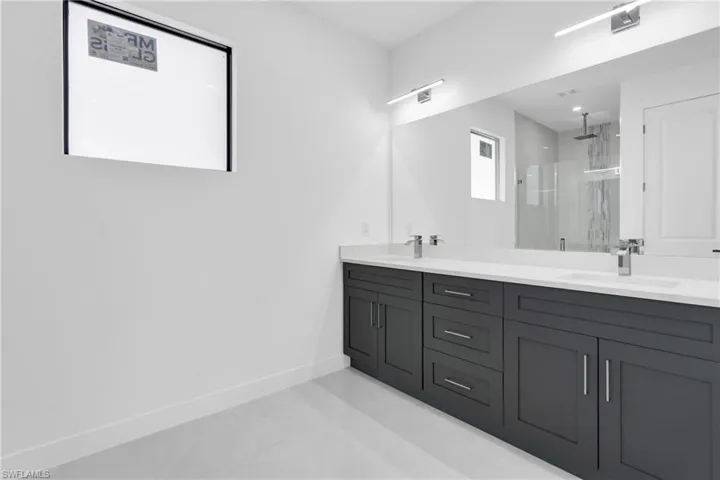 Bathroom with a shower stall and double vanity