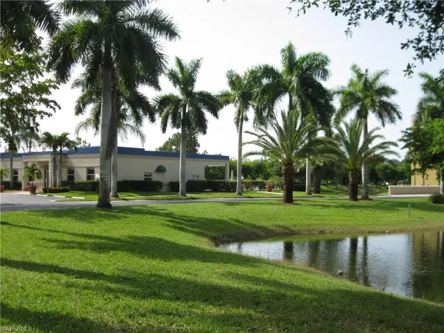 View of property's community clubhouse featuring a yard and a water view