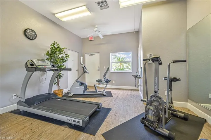 Workout room featuring a textured wall and a ceiling fan