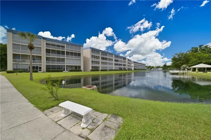 View of home's community with lovely landscaping and a water view