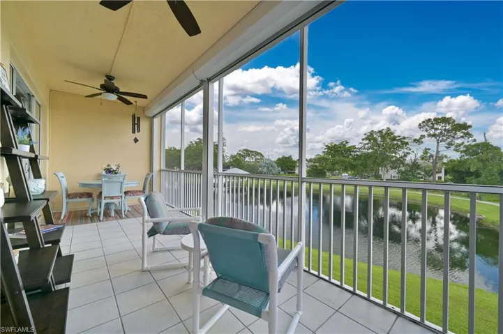 Lanai featuring a2 outdoor fans, water view and tile patterned flooring