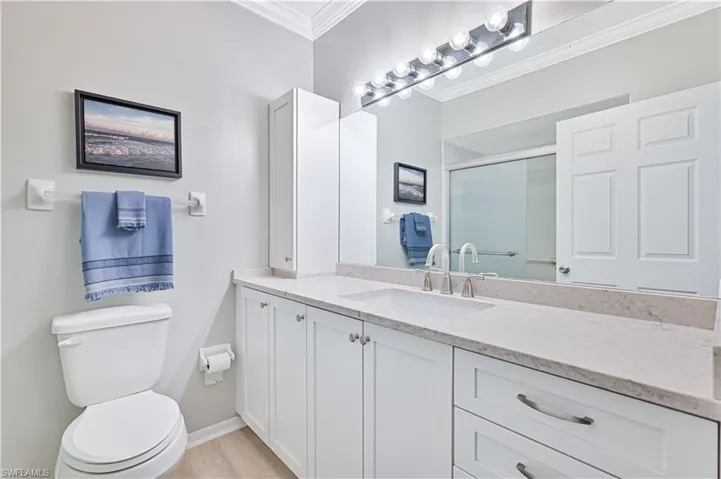 Full bath with new countertops, crown molding, vanity, and a stall shower